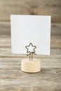 White note paper on a holder on wooden background Royalty Free Stock Photo