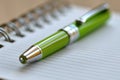 White notebook with a bright neon green pen creating a striking contrast and vibrant look Royalty Free Stock Photo