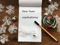 New year concept. New year resolutions. Planning. Goals. White notebook sheet. List of resolutions. Wooden table and pen. Christma Royalty Free Stock Photo