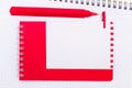 On a white notebook there is a red pen, a red notepad and a white blank sheet of paper with a place to insert text. Template Royalty Free Stock Photo