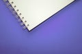 White notebook on violet background. Part of spiral notebook on very peri background- Color of the year 2022 Royalty Free Stock Photo