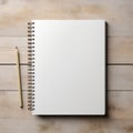 white notepad with a spiral mount and a white pen on a wood background