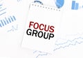 White notepad with text FOCUS GROUP on the financial documentation. Finance and business concept Royalty Free Stock Photo