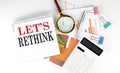 White notepad text LET S RETHINK with diagram, chart,calculator on white background Royalty Free Stock Photo