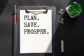 white notepad and text Plan. Save. Prosper. Royalty Free Stock Photo