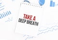 White notepad with text Take a deep breath on the financial documentation. Finance and business concept Royalty Free Stock Photo