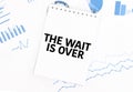 White notepad with text the wait is over on the financial documentation. Finance and business concept Royalty Free Stock Photo