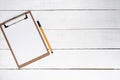 Blank notepad with yellow pen over white wooden background