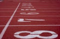 White number 1-8 on a starting line of a running track field. Royalty Free Stock Photo