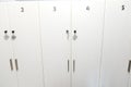 White numbered lockers in the corridor of the waiting room of a medical clinic or spa salon in minimalist stylish design Royalty Free Stock Photo