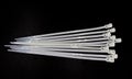 White nylon cable tie isolated on a black background Royalty Free Stock Photo