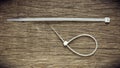 White nylon cable tie on old abandoned wood background. Royalty Free Stock Photo