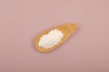 White oblong granules in wooden scoop. Food additive E202, preservative. Potassium sorbate, potassium salt of sorbic acid. It has