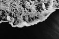 White ocean foam on black sand volcanic texture Royalty Free Stock Photo