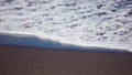 White ocean foam on black sand. Royalty Free Stock Photo