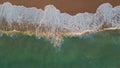 White ocean foam rolling sand closeup. Aerial turquoise water washing seashore Royalty Free Stock Photo