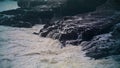 White ocean washing rocks on storm day. Closeup foaming waves hitting coastline Royalty Free Stock Photo