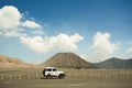 White off-road 4x4 adventure vehicle parking at sideway with the white and yellow milestone poles, bald mountain. Royalty Free Stock Photo