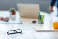 White office desk with glasses in black frame close-up. Royalty Free Stock Photo