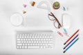 White office desk table with computer mouse and keyboard, cup of latte coffee, pencils and eye glasses. Top view with copy space, Royalty Free Stock Photo