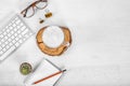 White office desk table with computer mouse and keyboard, cup of latte coffee, pencils and eye glasses. Top view with copy space, Royalty Free Stock Photo