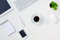 White Office Desk Table with Electronic Gadgets and Stationery Coffee Cup and Flower Royalty Free Stock Photo