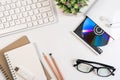 White office desk table with office equipment book, keyboard, earphone, cd or dvd rom, glasses and pencil with copy space. Royalty Free Stock Photo