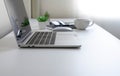 White office desk table with keyboard of laptop, coffee cup and notebook, mouse computer with equipment office supplies. Royalty Free Stock Photo