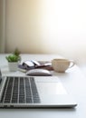 White office desk table with keyboard of laptop, coffee cup and notebook, mouse computer Royalty Free Stock Photo