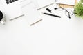 White office desk table with laptop, blank little notebook with pen and supplies. Top view with copy space, flat lay Royalty Free Stock Photo