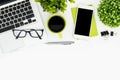 White office desk table with laptop, coffee, supplies and plants. Top view with copy space, flat lay Royalty Free Stock Photo