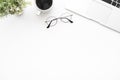 White office desk table with laptop computer, cup of coffee and supplies. Top view with copy space, flat lay Royalty Free Stock Photo