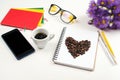 White office desk table with notebook, pen, glasses, cup of fresh espresso coffee. Spring flowers and mobile phone at table. Royalty Free Stock Photo