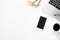 White office desk table with smartphone with blank mock up screen, laptop computer and supplies. Top view with copy space, flat Royalty Free Stock Photo