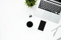 White office desk table with smartphone, laptop computer and supplies. Top view with copy space, flat lay Royalty Free Stock Photo