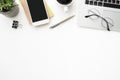 White office desk table with smartphone, laptop computer and supplies. Top view with copy space, flat lay Royalty Free Stock Photo