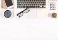 White office desk table, workspace office with laptop, smartphone black screen, coffee cup,pen,calculator, glasses, Top view with Royalty Free Stock Photo