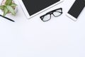 White office desk with tablet  smartphone  glasses and pen. Business  finance concept. Top view  flat lay and copy space Royalty Free Stock Photo