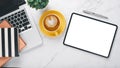 White office desk workplace with blank screen tablet computer, laptop, pen, notebook and cup of coffee, Royalty Free Stock Photo