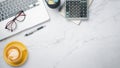 White office desk workspace with laptop computer, eyeglass, calculator, notebook, pen and cup of coffee, Top view flat lay with Royalty Free Stock Photo