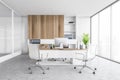 White office room with chairs, table and computer on marble floor with shelf