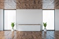 White office room with desk near wall, windows and plants in empty business room