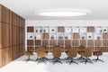 White office space with round chandelier and bright brown details