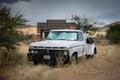 White old abandoned sixth generation Ford F-Series tow truck in the countryside