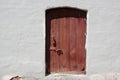 White old brick wall with weathered door or gate Royalty Free Stock Photo