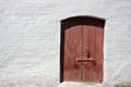 White old brick wall with weathered door or gate Royalty Free Stock Photo