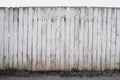 White old fence from boards, peeling paint, uneven fencing texture, high protection