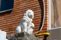 White, old lion statue flaunts on the rise Royalty Free Stock Photo