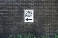 One Way Sign Posted on a Brick Wall Royalty Free Stock Photo