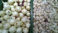 White onion and garlic on supermarket shelves. Retail industry. Grocery shopping. Royalty Free Stock Photo